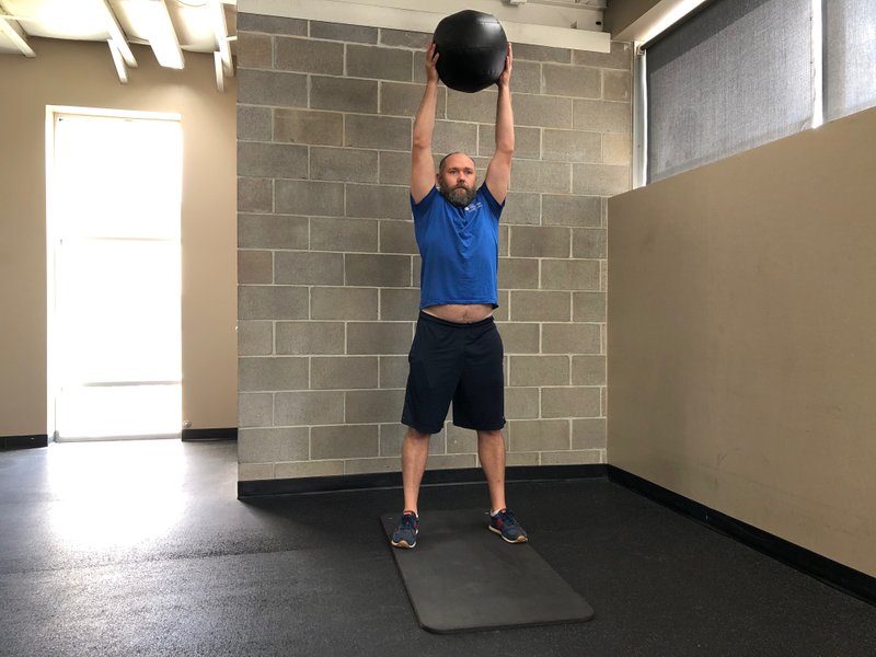 Michael Glenn, a personal trainer and massage therapist, demonstrates the Ground to Press at Little Rock Athletic Club. (Arkansas Democrat-Gazette/CELIA STOREY)