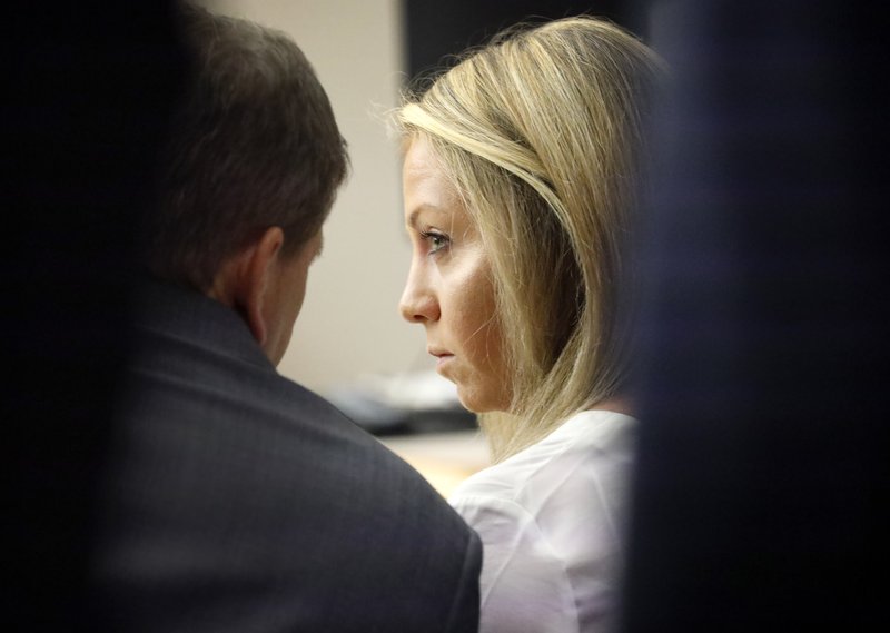 Former Dallas police officer Amber Guyger listens to her attorney Toby Shook during her trial at the Frank Crowley Courts Building in Dallas, Saturday, Sept. 28, 2019. Guyger shot and killed Botham Jean, an unarmed 26-year-old neighbor in his own apartment last year. She said she mistook his fourth-floor apartment for her own. (Tom Fox/The Dallas Morning News via AP, Pool)

