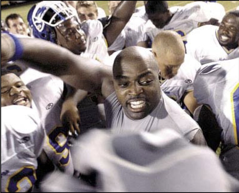 Former Magnolia High and Southern Arkansas running back Tony McDonald, as a 30-year-old collegiate starter, celebrates a victory with his Mulerider teammates in this October 2007 Arkansas Democrat-Gazette file photo. The Magnolia native who overcame a near decade absence from the game he loved to become a three-year starter for SAU passed away Sunday at 42.
