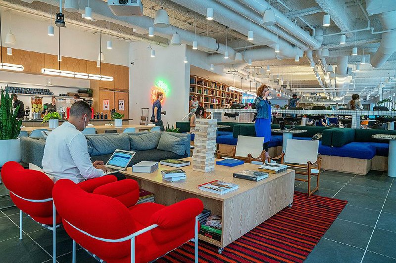 Members work in a cafeteria and lounge area at the WeWork office on Broad Street in Manhattan on May 22. 