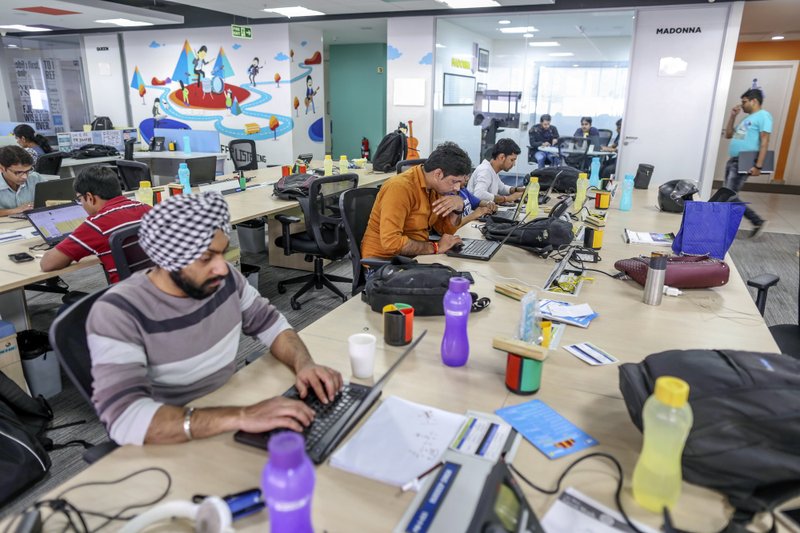 Employees work on laptops in 2017 at the Flipkart Online Services headquarters in Bengaluru, India. “Walmart’s and Flipkart’s commitment to India is deep and long-term,” one Walmart executive says. 