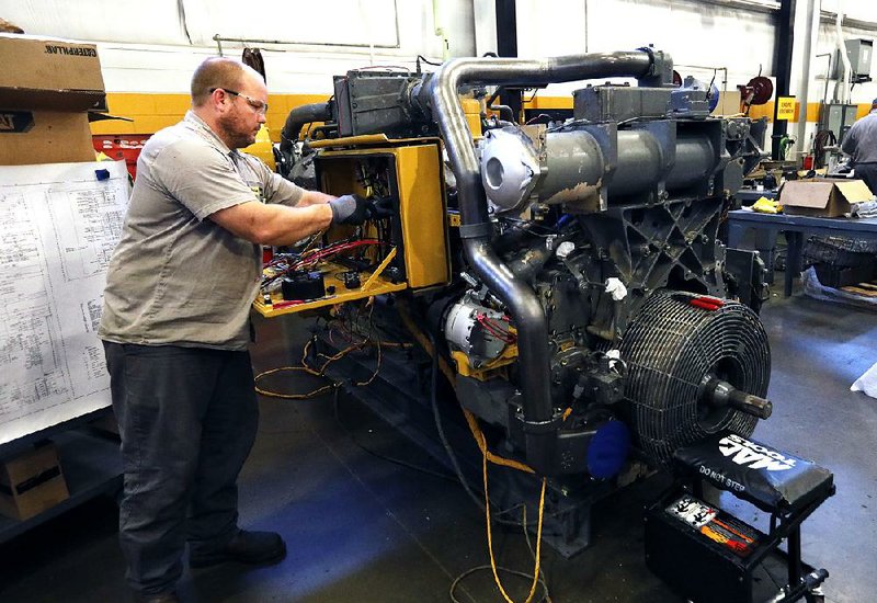 A technician works to update the electrical system on a Caterpillar machine last month at the Puckett Machinery Co. in Flowood, Miss. September was the worst month for U.S. manufacturing since June 2009, according to the Institute for Supply Management. 