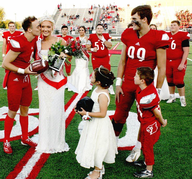 MARK HUMPHREY ENTERPRISE-LEADER Senior Drew Sturgeon kisses newly-crowned Homecoming queen Kally Stout on the cheek while attendants, Anna Benish and Harlan Pettigrew along with their escort, senior Ben Macedo, and the rest of Farmington's 2019 Homecoming cast look on. Farmington celebrated Homecoming Friday with ceremonies at Cardinal Stadium prior to the 22-21 football win over Clarksville.