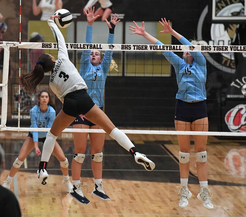 NWA Democrat-Gazette/J.T. WAMPLER Bentonville's Trinity Hamilton (3) gets a kill while Springdale Har-Ber's Caylan Koons (3) and Kat Cooper defend Tuesday Oct. 1, 2019 at Tiger Arena in Bentonville.