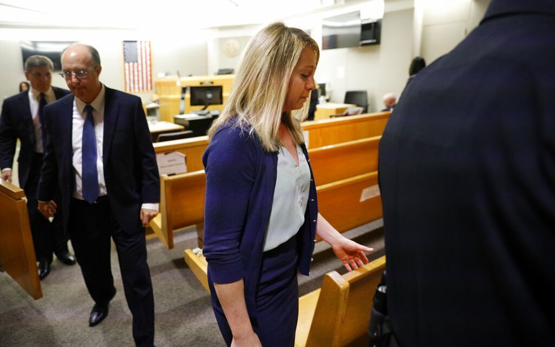 Fired Dallas police officer Amber Guyger leaves the courtroom after a jury found her guilty of murder Tuesday, Oct. 1, 2019, in Dallas. Guyger shot and killed Botham Jean, an unarmed 26-year-old neighbor, in his own apartment in 2018. She told police she thought his apartment was her own and that he was an intruder. (Tom Fox/The Dallas Morning News via AP, Pool)