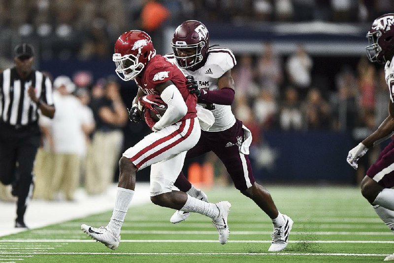 NWA Democrat-Gazette/CHARLIE KAIJO Arkansas Razorbacks wide receiver Mike Woods (8) carries the ball during the fourth quarter of a football game, Saturday, September 28, 2019 at AT&T Stadium in Arlington, TX.  

