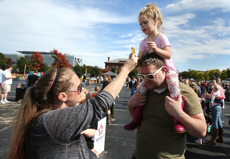 A young guest and her parents sample dips at last year's World Cheese Dip Championship. This year's festival is making an extra effort to be family-friendly. Arkansas Democrat-Gazette/Thomas Metthe