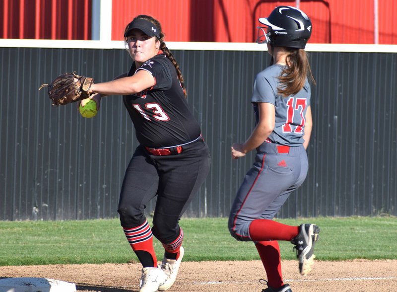 RICK PECK/SPECIAL TO MCDONALD COUNTY PRESS McDonald County third baseman Whitney Kinser throws to first to complete a double play after forcing out a Lamar runner during the Lady Mustangs' 3-1 win on Sept. 30 at MCHS.
