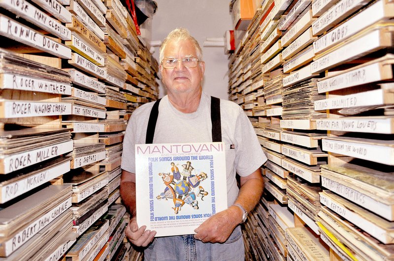 RACHEL DICKERSON/MCDONALD COUNTY PRESS Ed Malcolm of Pineville has been collecting records for 50 years and owns 8,000 albums. He is pictured on Sept. 9 among his custom-made shelves full of records.