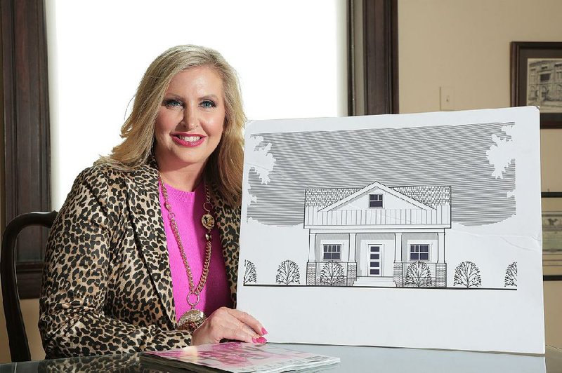 Heather Baker, publisher of AY magazine, is this year’s Women’s Own Worth Woman of the Year. Baker is shown with a rendering of the first of five transition homes for survivors of violence planned by WOW. The group’s annual WOWapalooza event on Saturday will raise money to build the home in Saline County. 