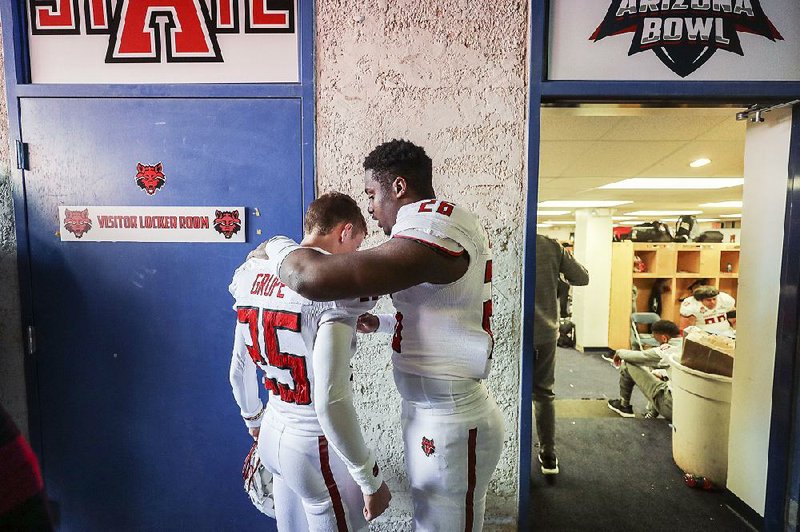 Arkansas State kicker Blake Grupe (left) gets some words of encouragement from safety Trent Ellis-Brewer during halftime of the Arizona Bowl on Dec. 29, 2018, at Arizona Stadium in Tucson, Ariz.. Grupe, who had just missed a field goal in the final seconds of the half, is having a strong season this year. 