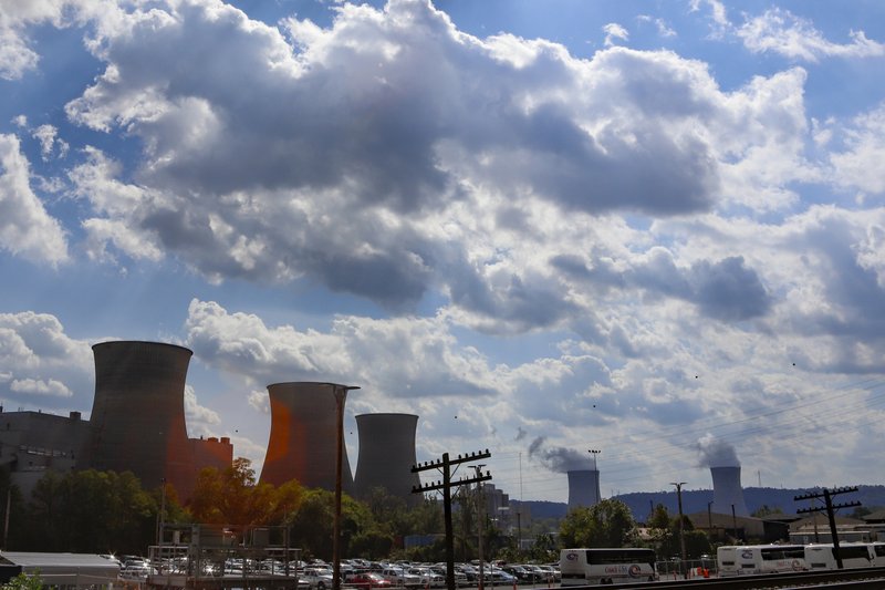 The Bruce Mansfield power plant in Shippingport, Pa., is seen from across the Ohio River from Industry, Pa. on Thursday, Oct. 3, 2019. Owners of coal-fired power plants, like the Bruce Mansfield plant that is scheduled to close next month, could pay more to emit carbon dioxide under Pennsylvania Gov. Tom Wolf's plan announced Thursday to bring Pennsylvania into a nine-state consortium that sets a price and limits on carbon dioxide emissions from power plants to help fight climate change. (AP Photo/Keith Srakocic)