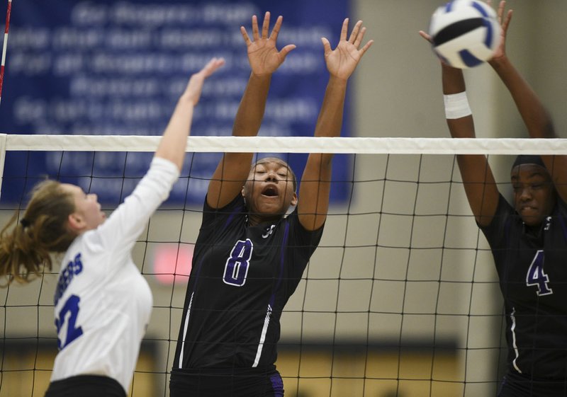 NWA Democrat-Gazette/CHARLIE KAIJO Fayetteville High School Rosana Hicks (8) and middle blocker Arianna Walter (4) block during a volleyball game, Thursday, October 3, 2019 at King Arena at Rogers High School in Rogers.