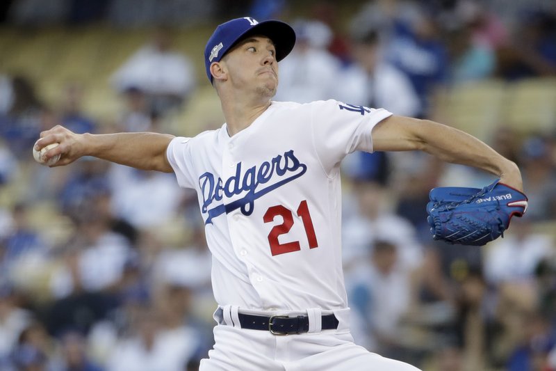 Los Angeles Dodgers starting pitcher Walker Buehler throws to a Washington Nationals batter during the first inning of Game 1 of a baseball National League Divisional Series on Thursday, Oct. 3, 2019, in Los Angeles. (AP Photo/Marcio Jose Sanchez)