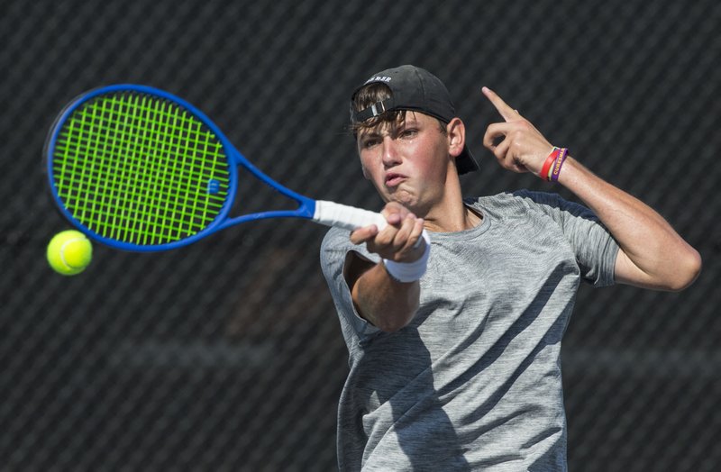 Hayden Shoemake of Bentonville West returns the ball Thursday, Oct. 3, 2019, while competing in the boys singles final match during the 6A West Conference Championship at Asbell Park in Fayetteville.