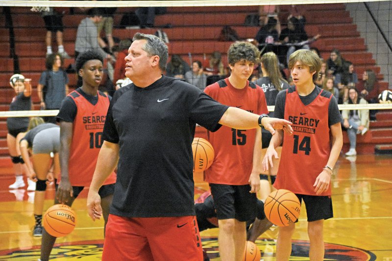 New Searcy Lions basketball coach Wayne Herren gives instructions to his team during a recent practice. Also pictured are Braden Watson, No. 10; Owenn Marino, No. 15; and Ethan Elsberry, No. 14.