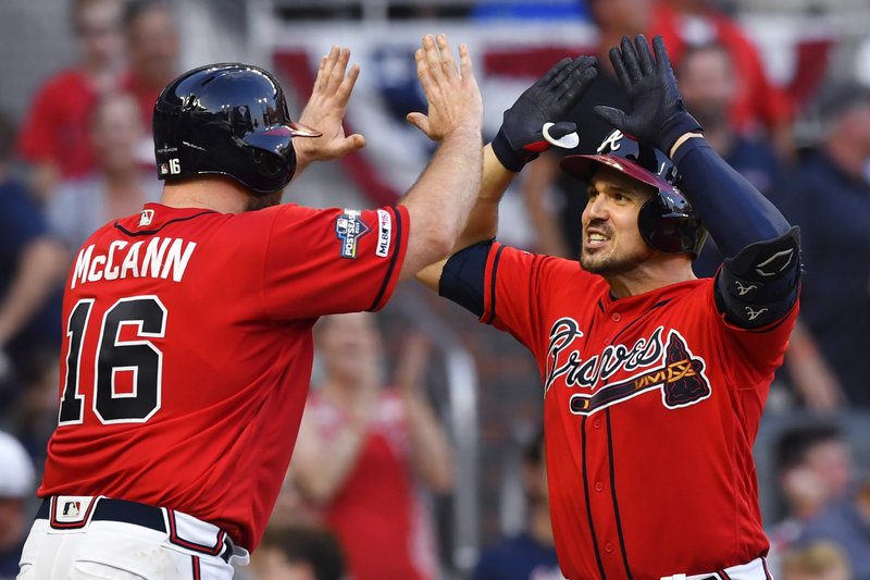 Adam Duvall of the Atlanta Braves looks on from the dugout during the