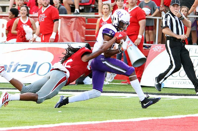 Central Arkansas wide receiver Kylan Robinson (right) runs though a tackle by a Nicholls State defender Saturday to score a touchdown during the Bears’ 34-14 loss to the Colonels in Thibodaux, La. 