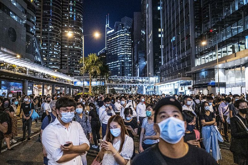 Mask-wearing activists gather Friday in Hong Kong in defiance of a prohibition on face coverings during protests. More photos are available at arkansasonline.com/105hongkong/ 