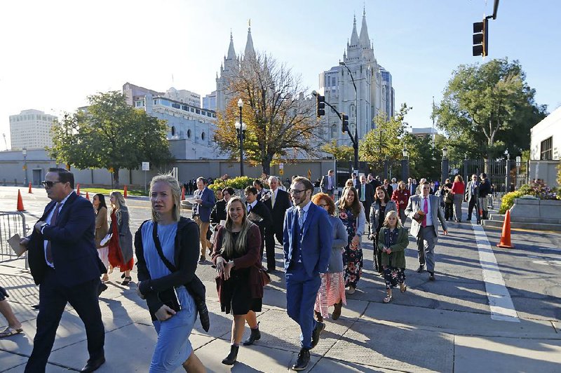 People arrive Saturday for The Church of Jesus Christ of Latter-day Saints’ twice-annual conference in Salt Lake City.