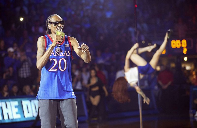 Rapper Snoop Dogg performs during Late Night in the Phog, Kansas’ annual basketball kickoff at Allen Fieldhouse  in Lawrence, Kan. Kansas Athletic Director Jeff Long apologized for Snoop Dogg’s act, which featured stripper poles, dancers and profanity.  
