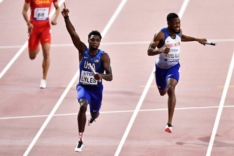 Noah Lyles (left) of the United States crosses the finish line to win the men’s 400-meter relay final ahead of Nethaneel Mitchell-Blake of Great Britain during the World Track and Field Championships on Saturday in Doha, Qatar. 