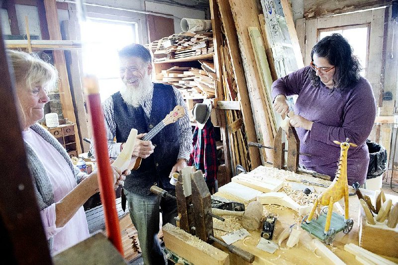 Folk artist Geoff Davis works with Debbie McBride (left) and Jamie Ribisi-Braley during a toy-carving workshop Friday at Sabbathday Lake Shaker Village in New Gloucester, Maine. 