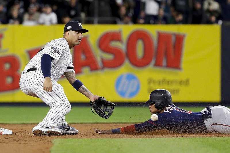 Jorge Polanco (11) of the Minnesota Twins steals second base while New York Yankees second baseman Gleyber Torres waits for the throw during the fifth inning of Friday’s American League division series game.