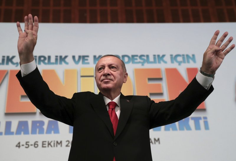Turkey's President Recep Tayyip Erdogan, waves to supporters during an event in Ankara, Turkey, Saturday, Oct. 5, 2019. Turkey's president threatened Saturday to launch a solo military operation into northeastern Syria, where U.S. troops are deployed and have been trying to defuse tension between its NATO ally and Syrian Kurdish forces. (Presidential Press Service via AP, Pool)