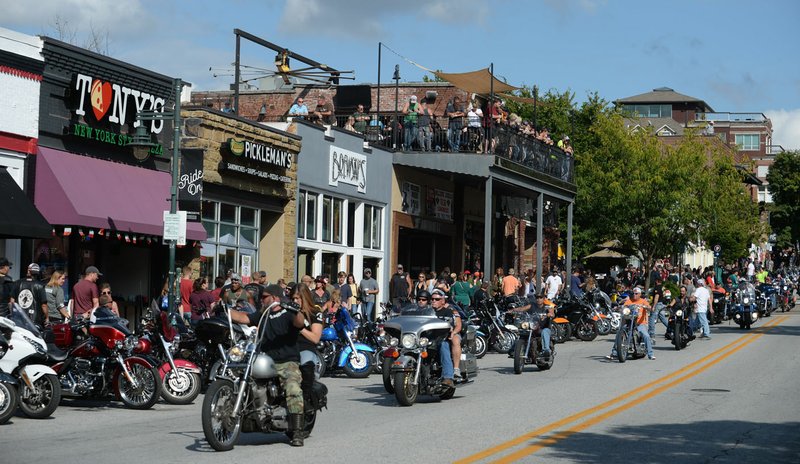 NWA Democrat-Gazette/ANDY SHUPE
Motorcyclists ride Sept. 28, 2019, along Dickson Street during the 20th annual Bikes, Blues &amp; BBQ Motorcycle Rally in Fayetteville. A group of residents took to social media to post pictures of materials they found offensive during the rally.