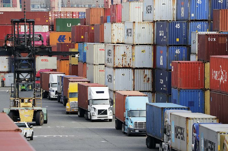 Trucks haul shipping containers last week at a terminal on Harbor Island in Seattle. Trade talks between the U.S. and China are scheduled to resume Thursday. 