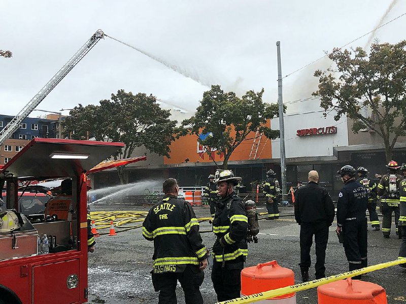 Firefighters work Monday at the scene of a blaze that engulfed several businesses in Seattle’s Ballard neighborhood. Authorities said it took more than three hours to get the fire under control.