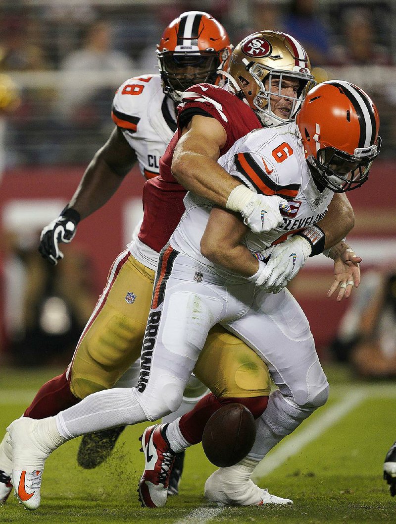 San Francisco 49ers defensive end Nick Bosa (center) sacks Cleve- land Browns quarterback Baker Mayfield, forcing a fumble during Monday’s game in Santa Clara, Calif. The 49ers won 31-3. 