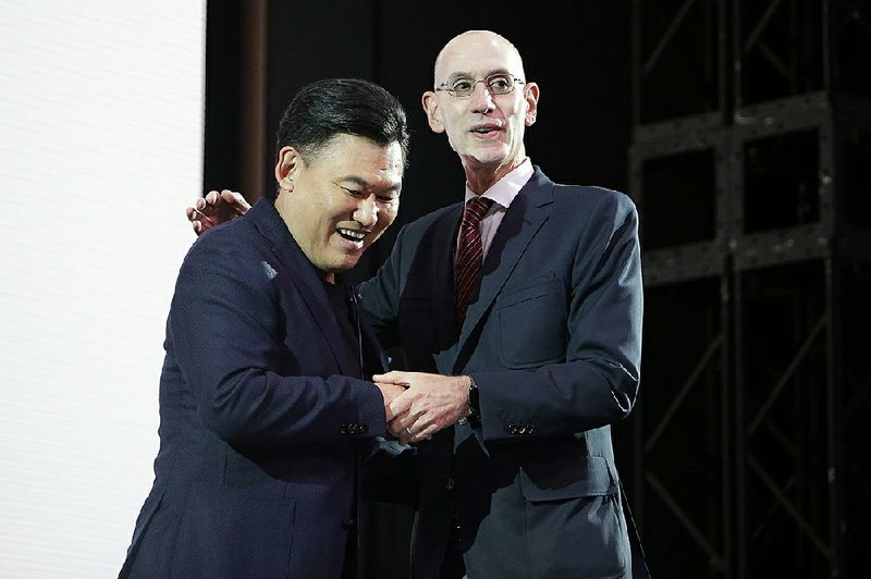 NBA Commissioner Adam Silver (right) and Mickey Mikitani, chairman & CEO of Rakuten, Inc., greet each other during a welcome reception for the NBA Japan Games 2019 between the Toronto Raptors and the Houston Rockets on Monday in Tokyo. 
