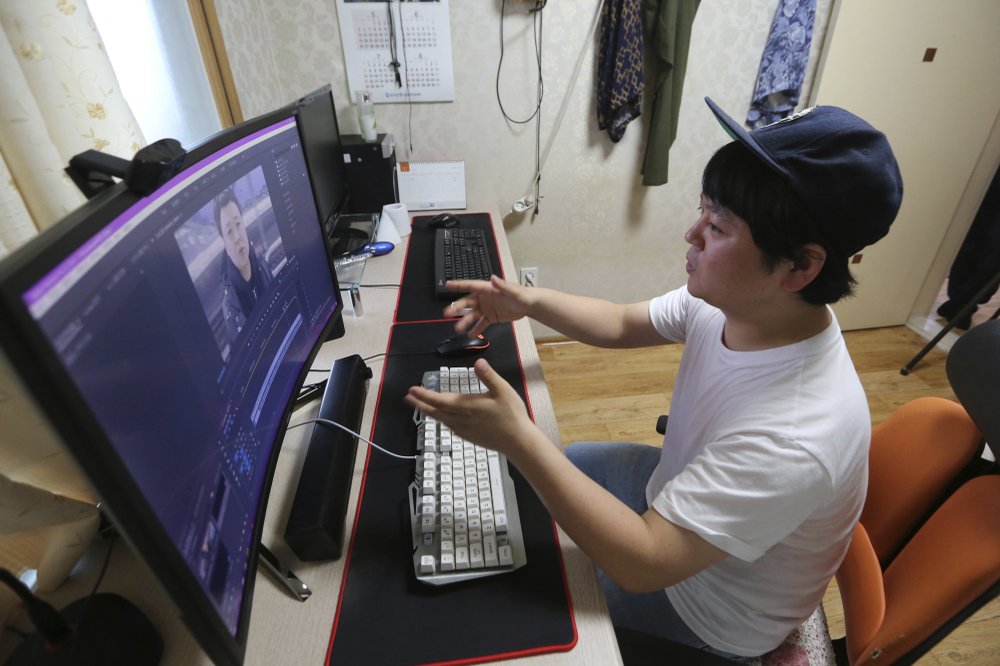 North Korean refugee Jang Myung-jin edits his YouTube footage during an interview at his house in Seoul, South Korea in July. Back home in North Korea, Jang's YouTube channel would never be possible. (Photo by Ahn Young-Joon via AP)