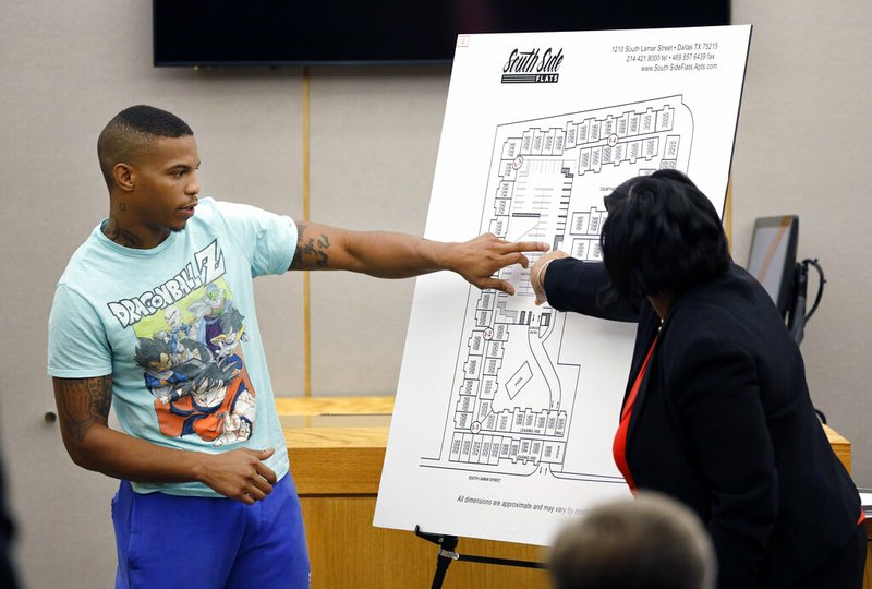 In this Tuesday, Sept. 24, 2019, photo, victim Botham Jean's neighbor Joshua Brown, left, answers questions from Assistant District Attorney LaQuita Long, right, while pointing to a map of the South Side Flats where he lives, while testifying during the murder trial of former Dallas Police Officer Amber Guyger, in Dallas. Authorities say that Brown was killed in a shooting Friday, Oct. 4. (Tom Fox/The Dallas Morning News via AP, Pool)