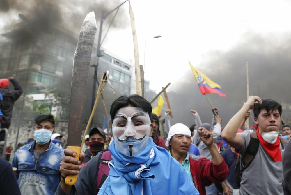 Violent protests in Ecuador force government to move