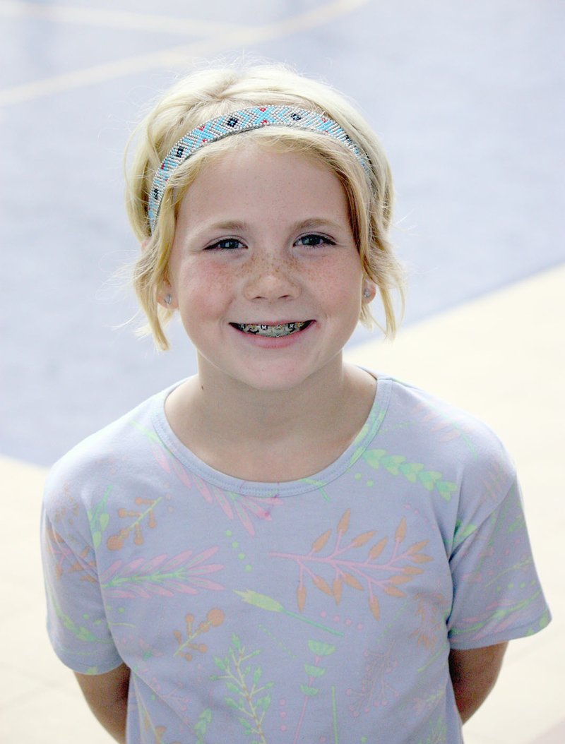 MARK HUMPHREY ENTERPRISE-LEADER Jolie Vaughn, 9, of West Fork, sang the Star Spangled Banner at a West Fork volleyball match against Lincoln Tuesday, Sept. 24, 2019, and fired up the home team as the Lady Tigers swept Lincoln (25-8, 25-15, 25-9).