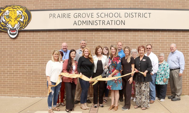 LYNN KUTTER ENTERPRISE-LEADER Prairie Grove Area Chamber of Commerce recently sponsored a ribbon-cutting ceremony for the new school administration office, located at the corner of Buchanan and Mock streets in downtown Prairie Grove. The school hosted the chamber for its September meeting and as part of the meeting, gave the Annual Report to the Public.