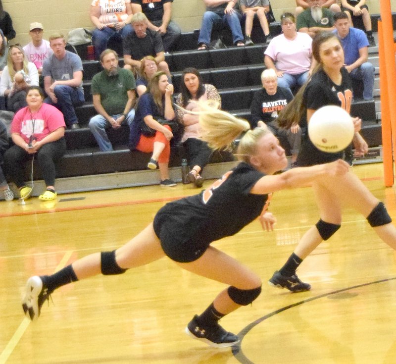 Westside Eagle Observer/MIKE ECKELS Lady Lion Nicole Vogt uses a one-armed dig to save a Berryville pass during the Thursday Gravette-Berryville volleyball contest at Gravette High School. Vogt managed to get the ball back into Lady Bobcat territory.