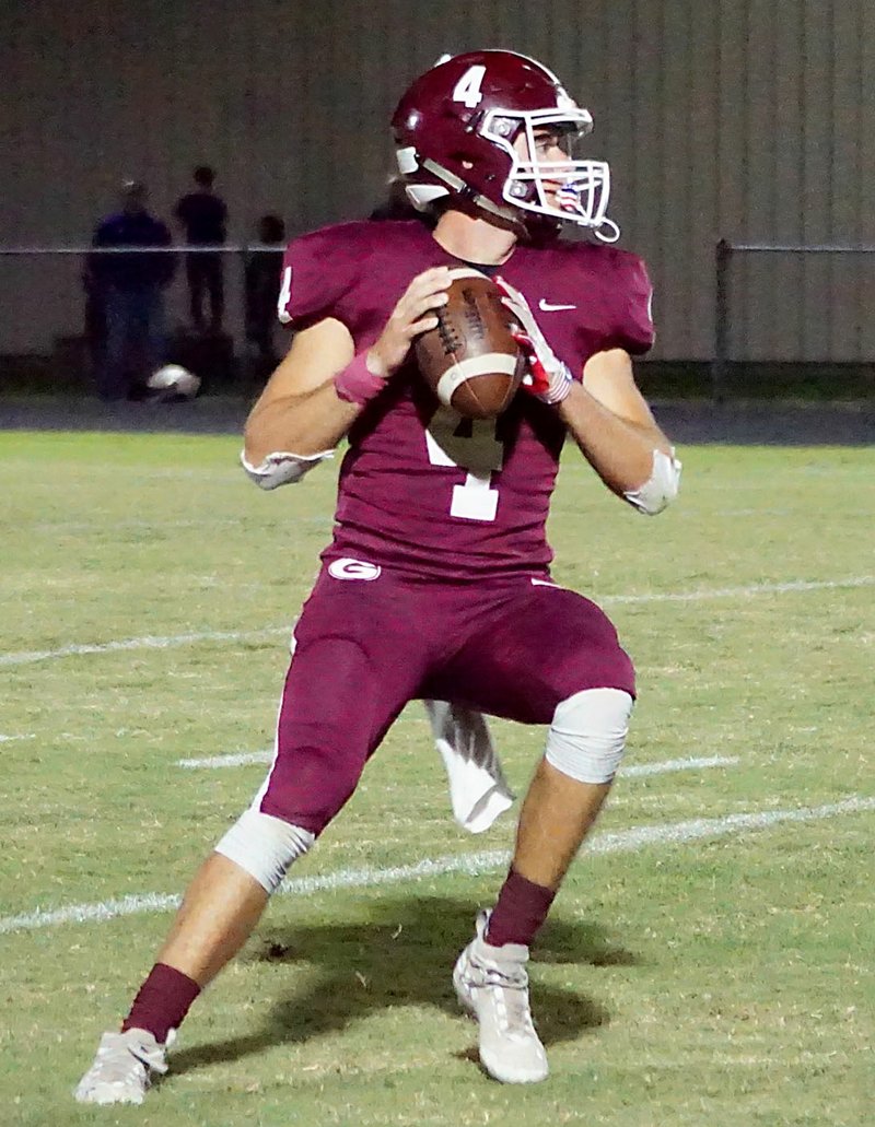 Westside Eagle Observer/RANDY MOLL Gentry senior quarterback Brandon Atwood looks downfield for an open receiver during play against Berryville on Friday at Gentry High School.