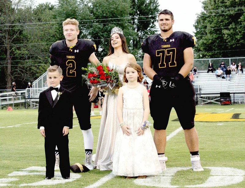 MARK HUMPHREY ENTERPRISE-LEADER/Prairie Grove 2019 Homecoming queen Olivia Stroud poses with escorts, senior Graham Guenther (left) and senior Hayden Black, along with attendants, Barrett Watson and Ella Davis. The Tigers won Friday's Homecoming game by a 48-7 score over Gravette.