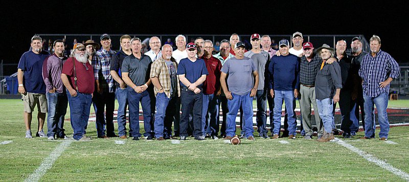 Westside Eagle Observer/RANDY MOLL Members of the 1979 Gentry High School football team, along with their coach, Dick Johnson, were honored on the field at the halftime of Gentry's homecoming game on Friday. The team holds the record for the most wins in a season for Gentry. The team was 11-0 and lost its 12th game in the semifinals of the state playoffs.