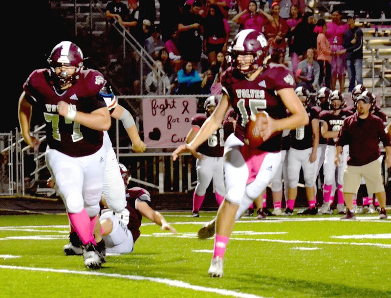 Annette Beard Special to the Enterprise-Leader/Lincoln junior quarterback Tyler Brewer scrambles while senior tackle Conner Brown looks to make a block during Friday's 55-21 loss to Pea Ridge.