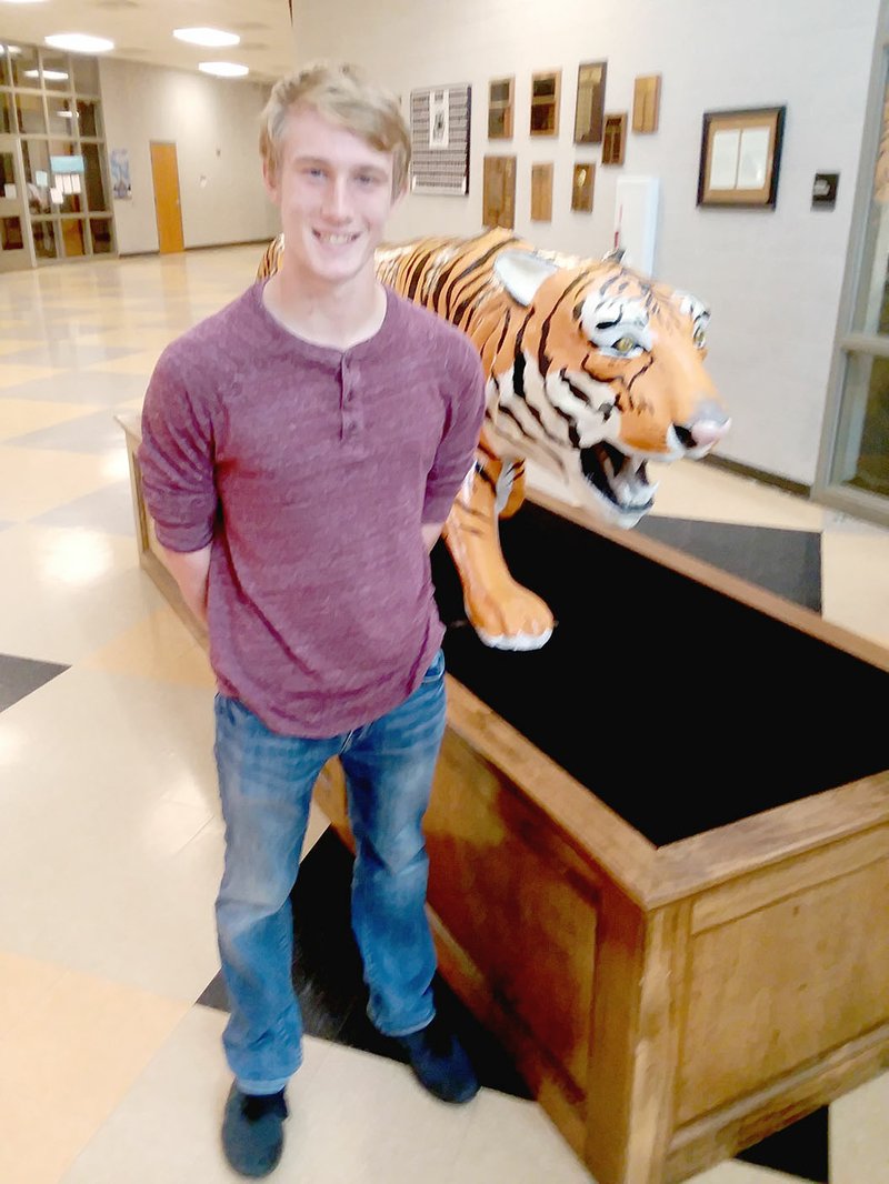 MARK HUMPHREY ENTERPRISE-LEADER/Prairie Grove sophomore John King poses by the Tiger mascot at the front entrance to the high school. King scored his first touchdown against Green Forest on Sept. 27 with an interception runback of 50 yards. That win and Friday's 48-7 victory over Gravette gives Prairie Grove (2-3, 2-0) going into this week's game against Shiloh Christian.