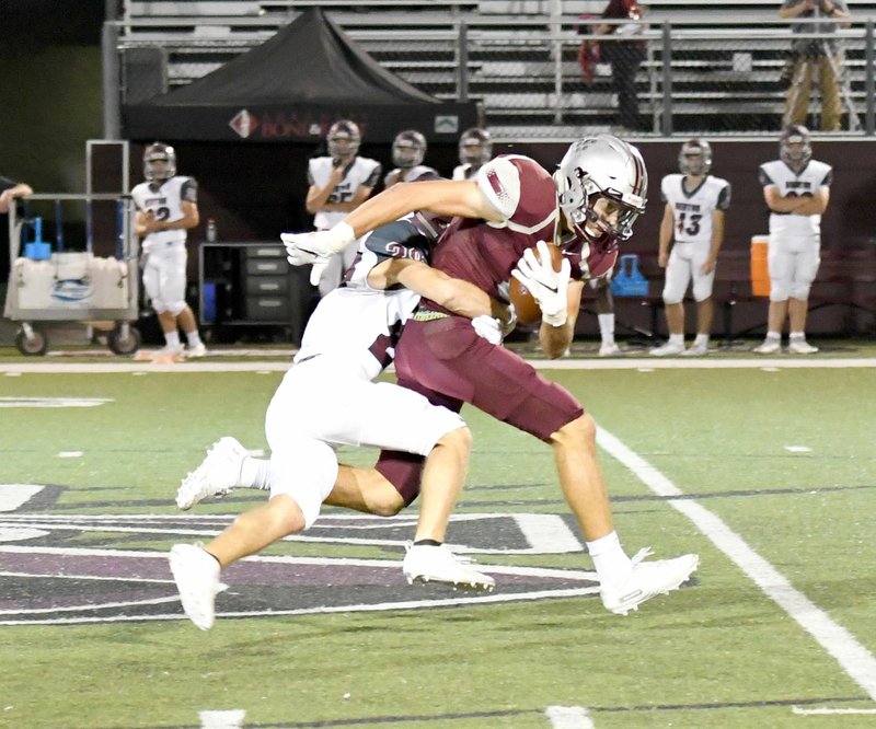 Bud Sullins/Special to the Herald-Leader Siloam Springs senior Oren Stafford runs with the ball after making a catch near midfield against Benton during last week's game at Panther Stadium.