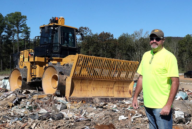 Billy Sawyer, standing in front of a compactor at the Cedar Glades Landfill Tuesday, will be the new director of the county's environmental services department starting next week. He's been the assistant director since 2015. - Photo by Richard Rasmussen of The Sentinel-Record story.lead_photo.caption