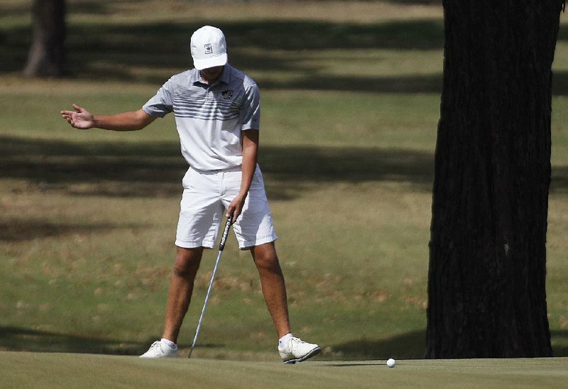 Bentonville’s Phisher Phillips reacts after missing a putt on the fifth hole during Wednesday’s second round of the Class 6A boys state golf tournament in Sherwood. Phillips led Bentonville to the team title after the Tigers defeated Little Rock Catholic in a two-hole playoff. 