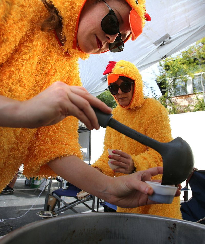 Erika Fischer (left) and her mother, Kay Fischer, scoop out gumbo samples at the 2018 HarvestFest in Hillcrest. Democrat-Gazette file photo/Thomas Metthe
 