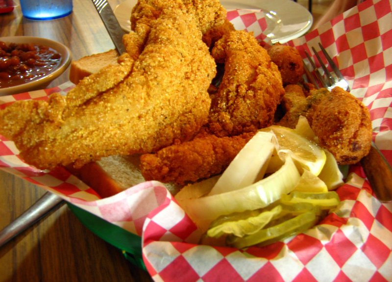 A three-piece catfish dinner at Magnolia Skillet in North Little Rock includes three filets, hush puppies, onion, pickles, lemon wedges and two sides. Arkansas Democrat-Gazette/Rosemary Boggs